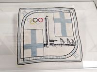 Object as presented in the display case. A top-down view of a rectangular, very lightweight handkerchief