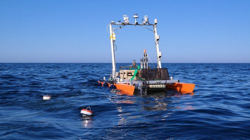 The new autonomous research catamaran on its first mission in the North Sea in early May. In the foreground, two measuring buoys can be seen passively drifting with the ocean currents and collecting data in the process [Photo: ICBM/Lisa Gassen].