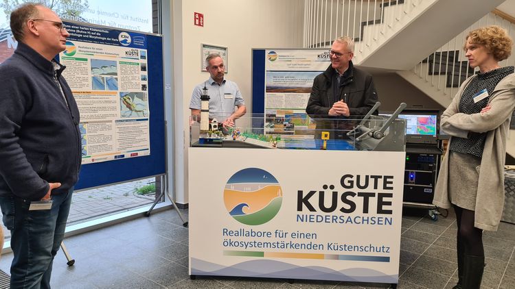 Thomas Badewien, Helge Ansgar Giebel, Björn Thümler and ICBM Deputy Director Katharina Pahnke talking about the project at the "Good Coast Lower Saxony" model [from left; Photo: S. Riexinger].