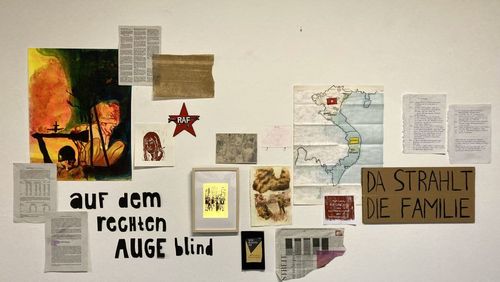 The picture shows a wall with the slogan "blind in the right eye", a map of Vietnam, an RAF sticker, pictures of combat operations and newspaper clippings.