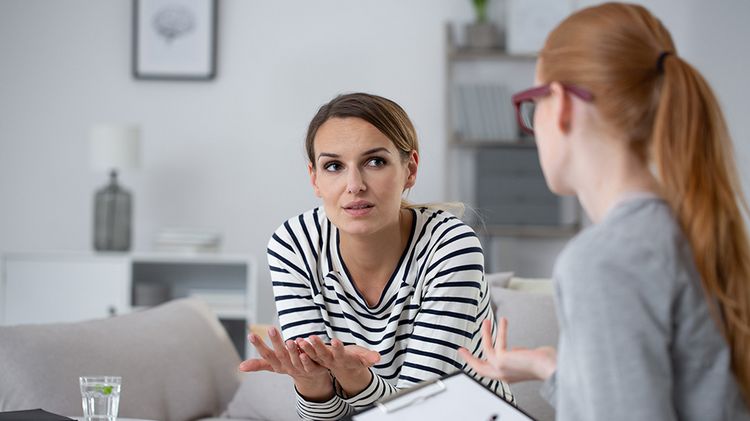 Two women are undergoing psychotherapeutic counselling.