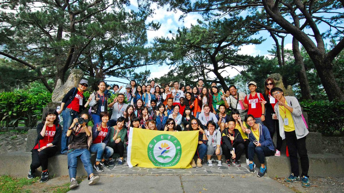 A group of NDHU students and staff on a hike in the forest.