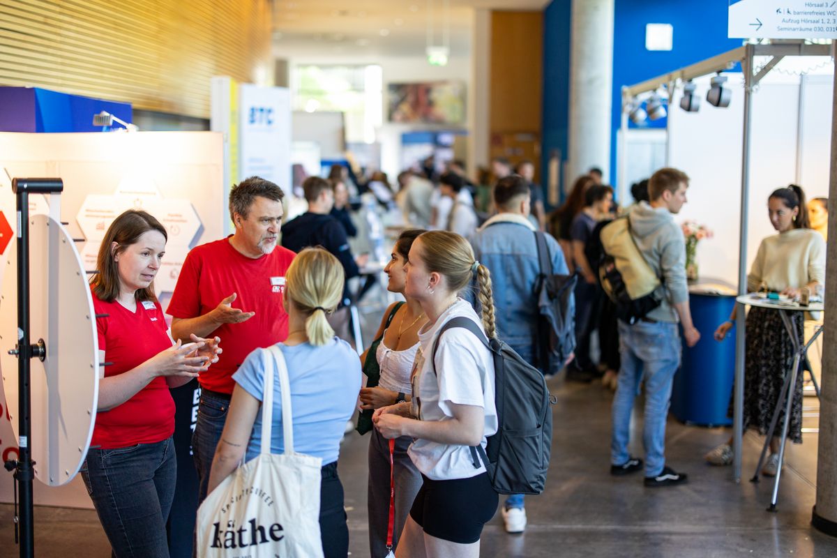 Besucher*innen und Ausstellende im Gespräch