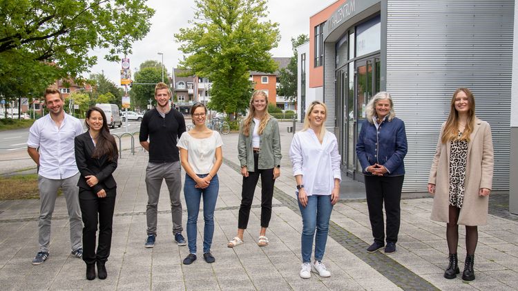Die acht Personen stehen vor dem Hörsaalzentrum.