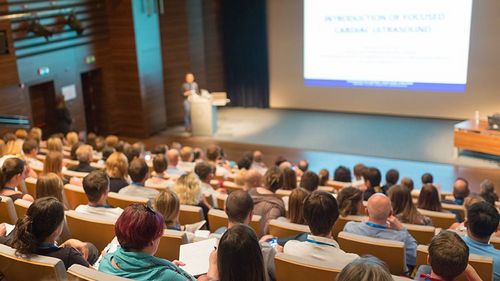 conference, business, event, meeting, speaker, businessman, lecture, talk, seminar, education, speech, lecture hall, convention center, summit, entrepreneur, educator, explaining, listeners, participants, group, chart, white screen, people, training, professional, corporate, conference hall, coaching, briefing, manager, entrepreneurship, academy, faculty, team, congress, workshop, institute, screen, university, presentation, public, sitting, teacher, teaching, audience, academic, convention, information, symposium, man