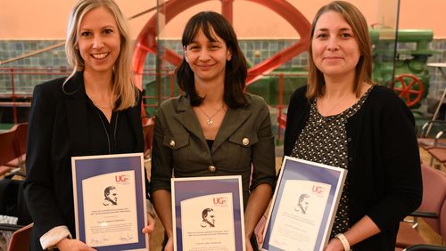 The three award winners on the evening of the ceremony holding their certificates. 