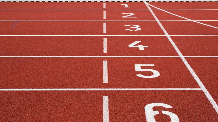 Close-up of a running track with the numbers of the different starting positions.