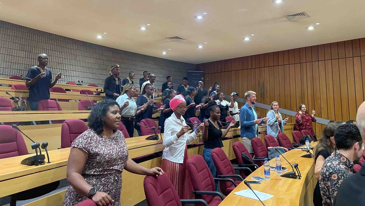 A lecture hall with a group of people moving in a lively and carefree manner.