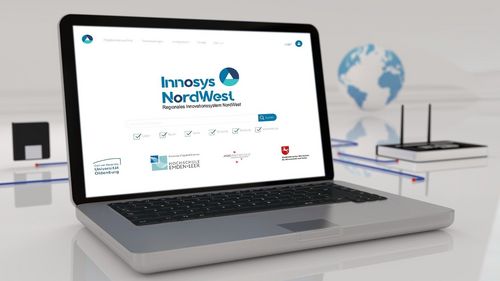 Opened laptop, the project logo can be seen on the screen.