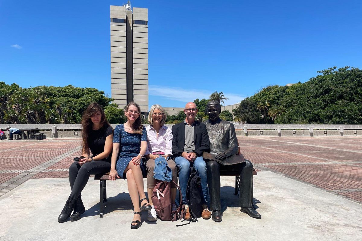 Gruppenbild mit Projektteilnehmenden vor der Mandela Statue auf dem South Campus der NMU