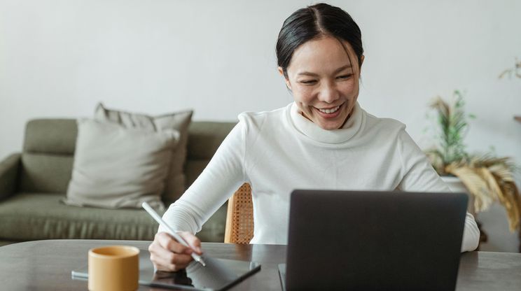 woman smiling at laptop screen