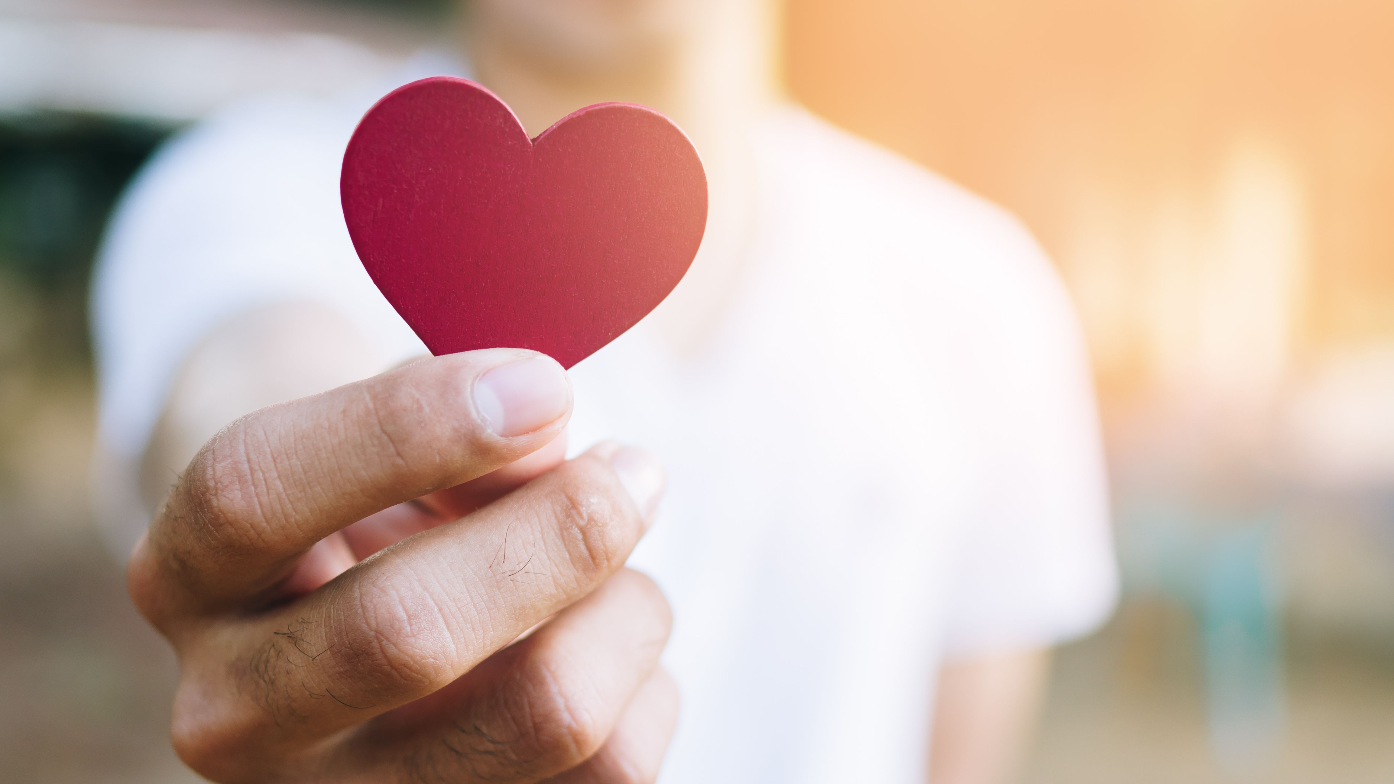 A cut-out heart in her hand.