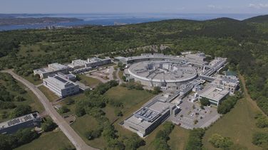 Aerial view of the plant in the green Italian landscape. 