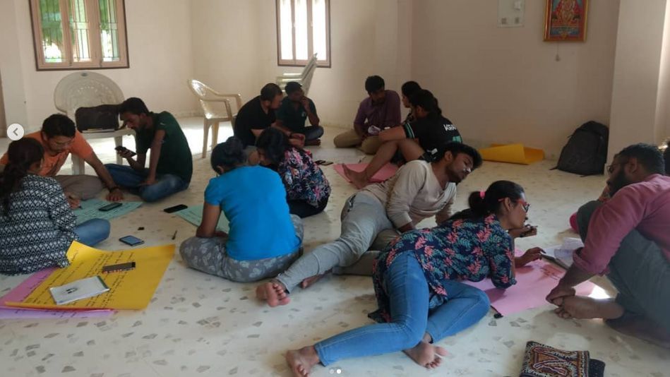 Studierende arbeiten an einem Projekt, während sie auf dem Boden sitzen.