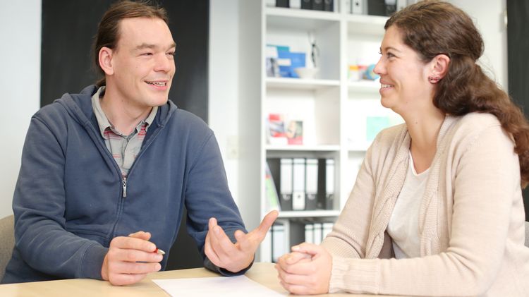 A counselling situation. Two people are talking.