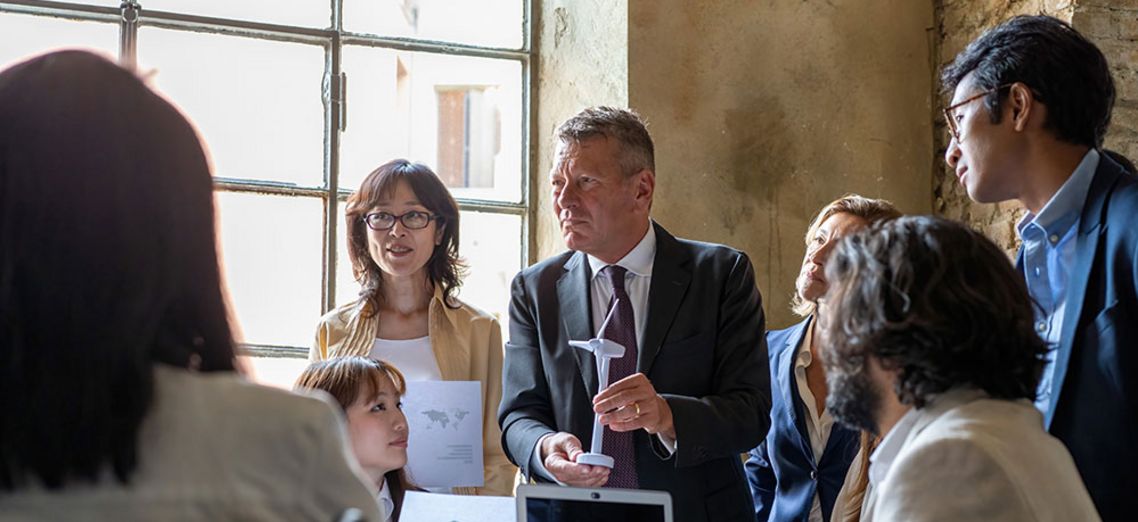 Manager discusses wind energy with diverse team