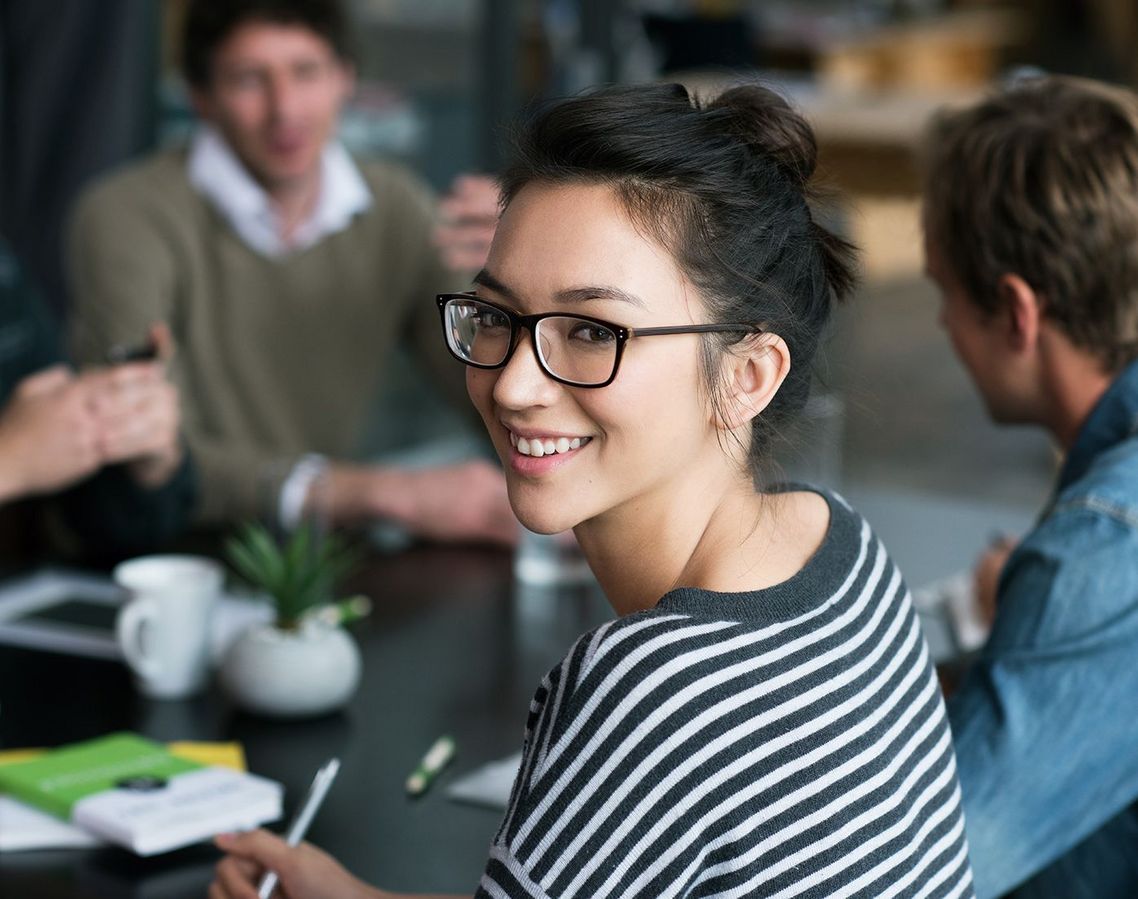 Auf dem Bild sind vier glückliche und zufriedene Menschen zu sehen, welche die Zielgruppe der Weiterbildung repräsentieren.