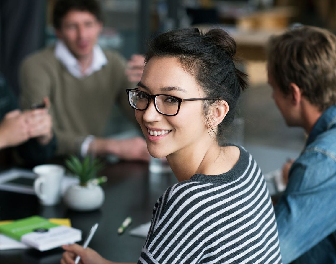 Auf dem Bild sind vier glückliche und zufriedene Menschen zu sehen, welche die Zielgruppe der Weiterbildung repräsentieren.