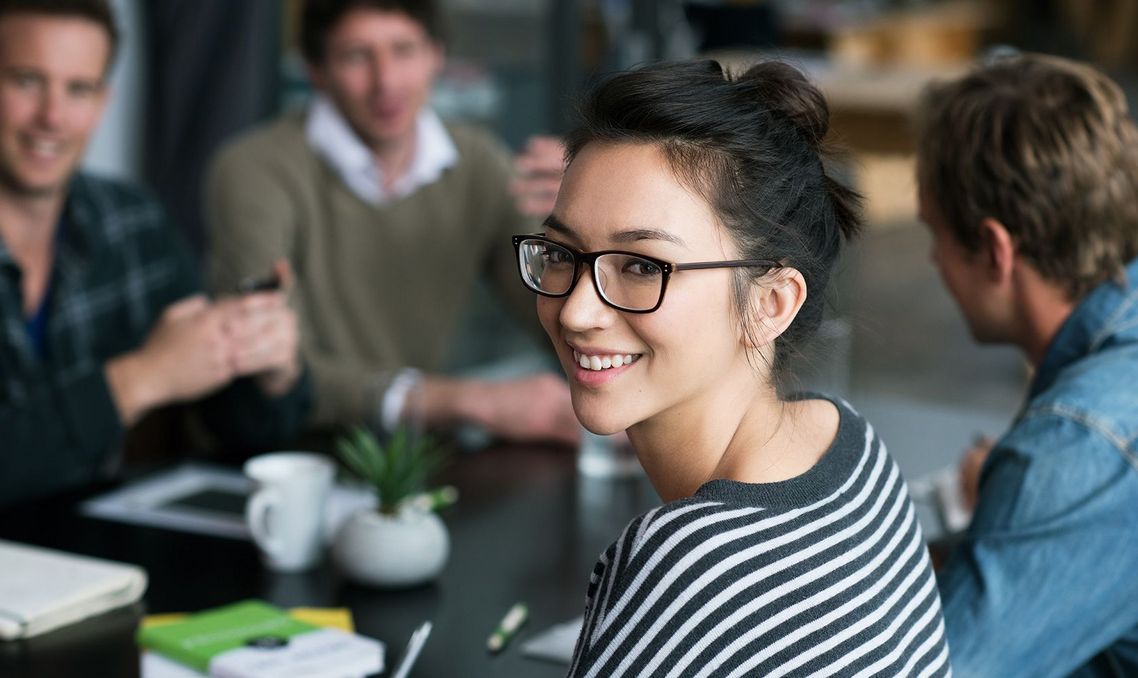 Auf dem Bild sind vier glückliche und zufriedene Menschen zu sehen, welche die Zielgruppe der Weiterbildung repräsentieren.