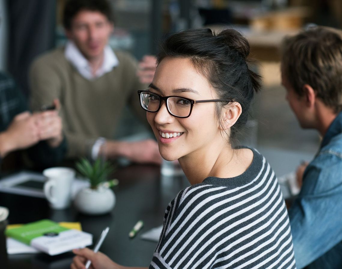 Auf dem Bild sind vier glückliche und zufriedene Menschen zu sehen, welche die Zielgruppe der Weiterbildung repräsentieren.