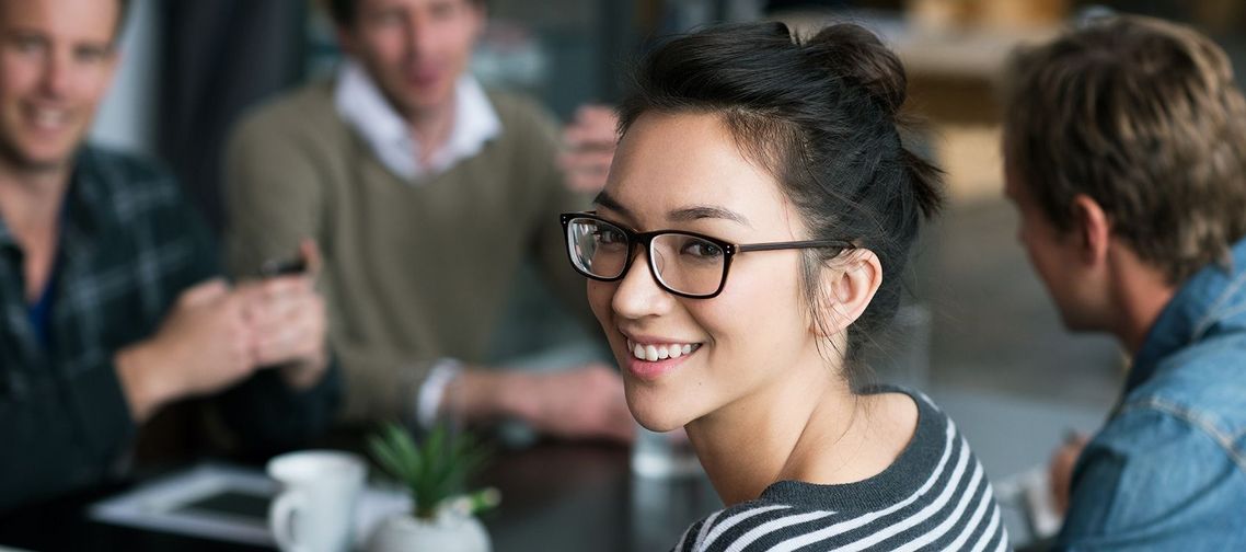 Auf dem Bild sind vier glückliche und zufriedene Menschen zu sehen, welche die Zielgruppe der Weiterbildung repräsentieren.