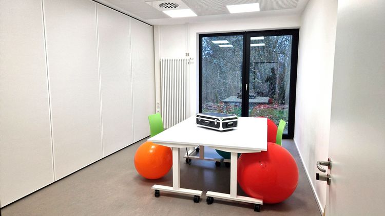 View of a smaller room with two tables and six Pezzi balls.