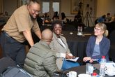 Dr Anne Clausen interacting with three people at the research funding workshop at NMU