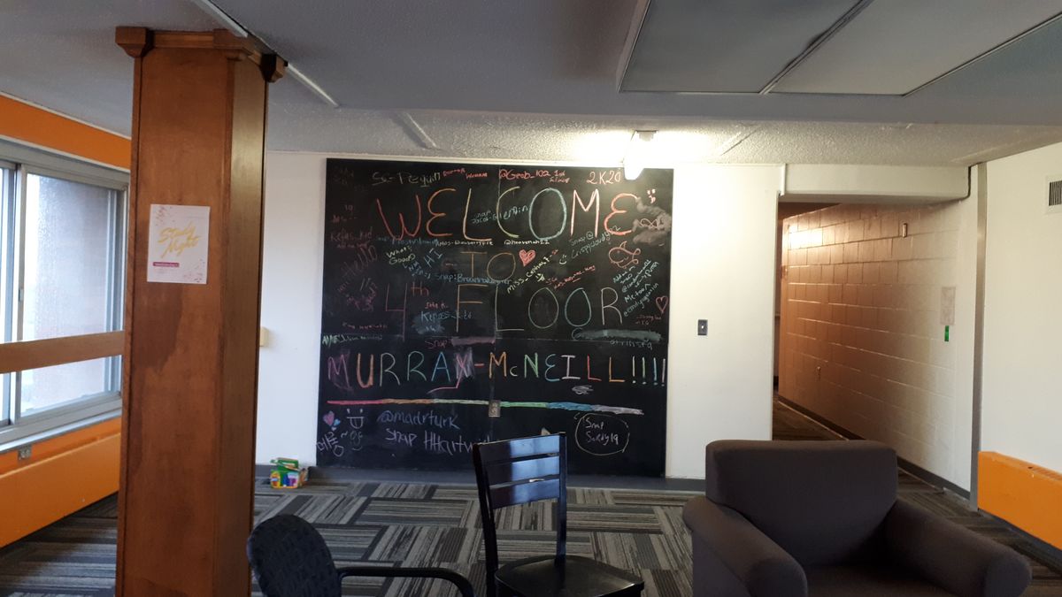 Welcome board in a hall of residence, on which welcome greetings were written in different languages with chalk