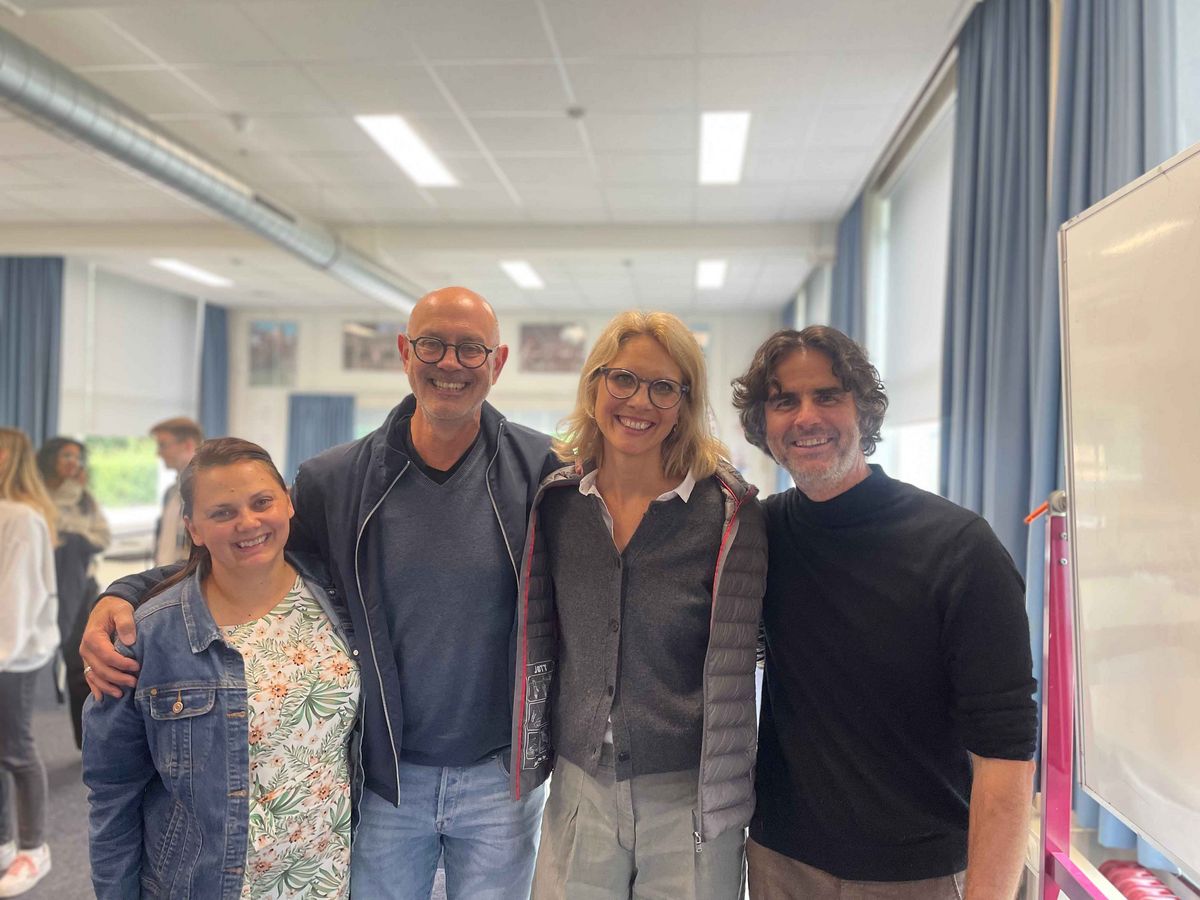 A group of organizers from the "Teaching Across Borders" event smiling and posing for a photo.
