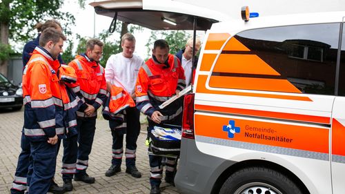 Paramedics at the emergency vehicle.