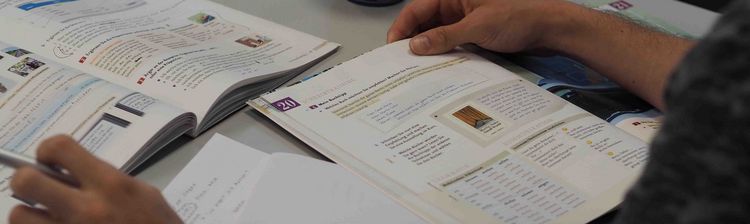 A bird's-eye view of a learning space with textbooks and worksheets.