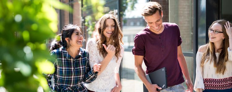 Four people talking and laughing.