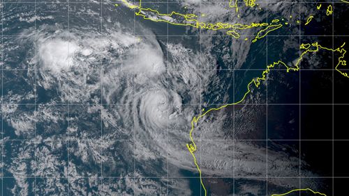 Satellite image of the two cyclones shortly before merging. The contours of Australia and Indonesia can be seen for orientation.