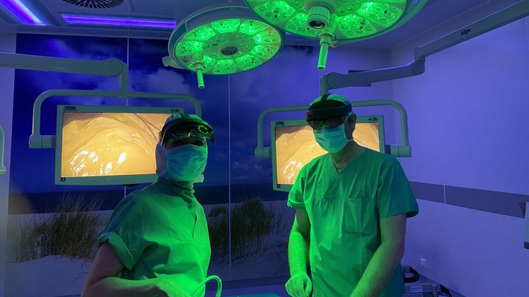 Doctor in an operating theatre with green and purple light